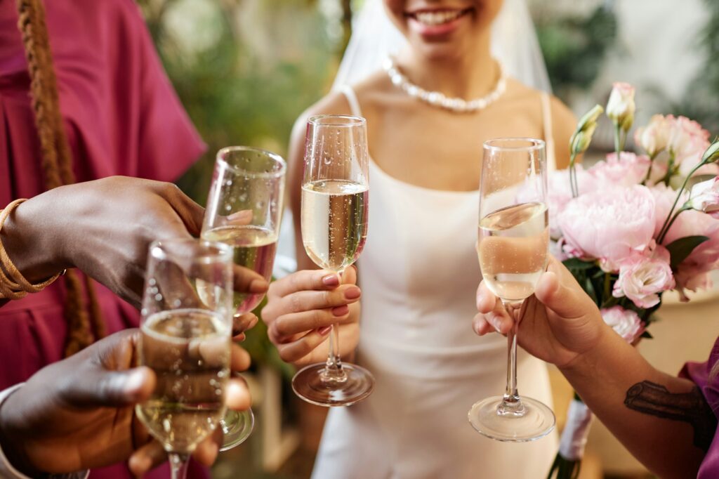 People celebrating and toasting with Champagne glasses during wedding